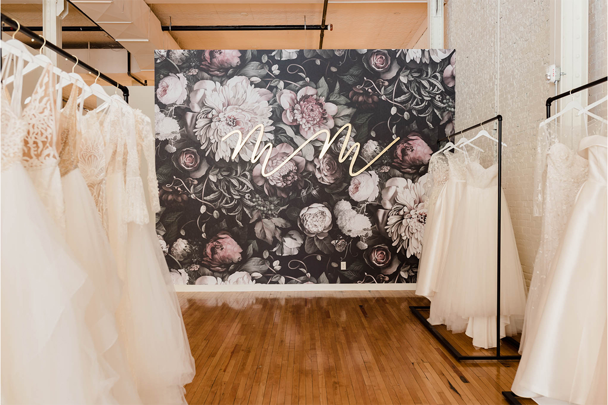 Wedding gowns hanging on racks in Marie and Marie Bridal.
