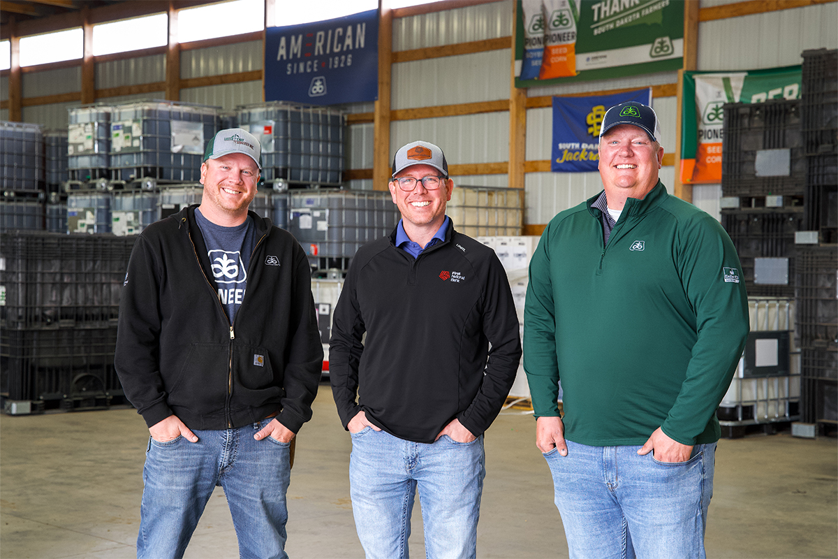 Rob Thuringer, Brian Gilbert, and Dave Ellens standing in the Lakeco warehouse.