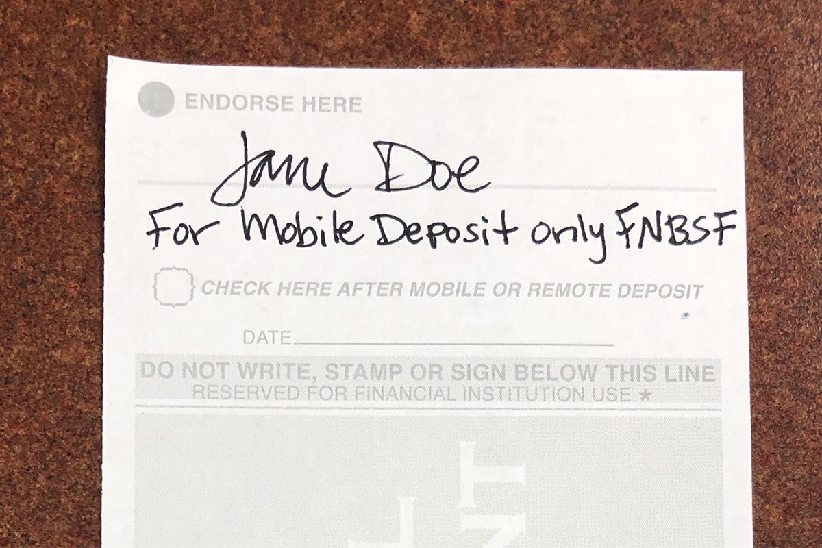 The back of check indorsed with "For mobile deposit only FNBSF."