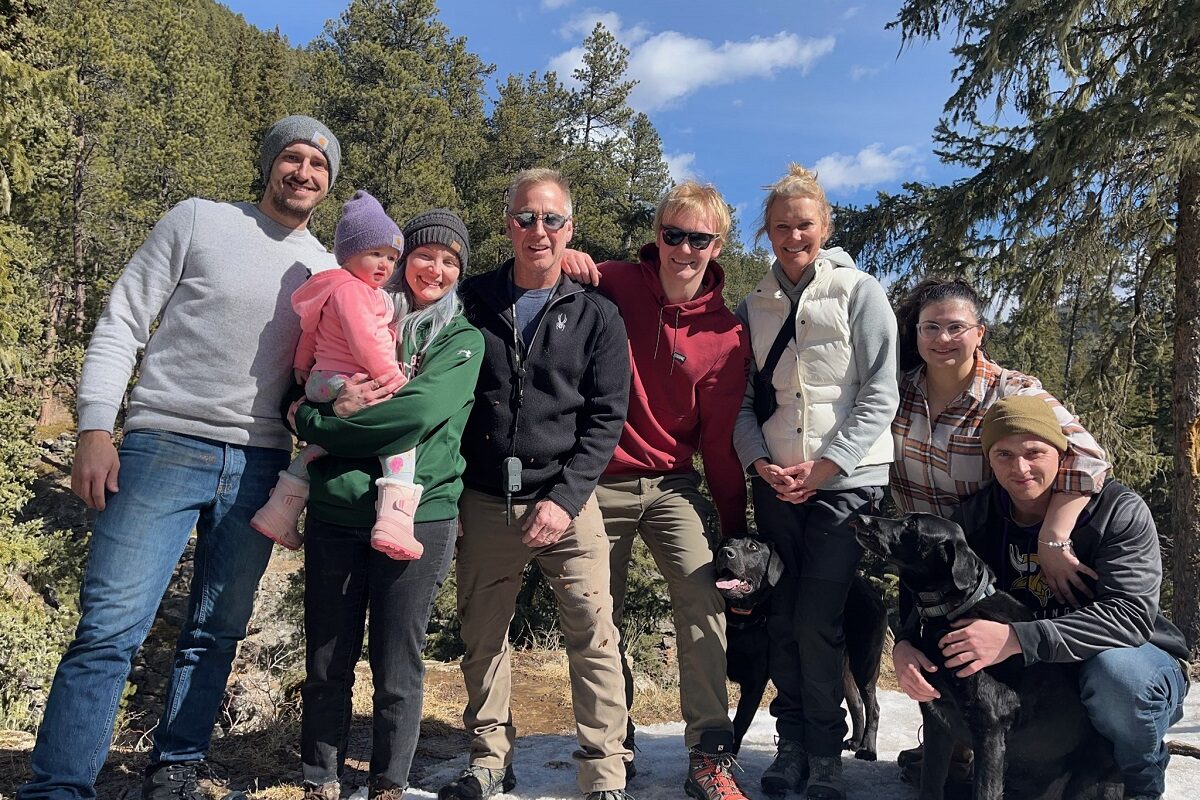 Terri Foster's family posing for a group picture while on a hike.