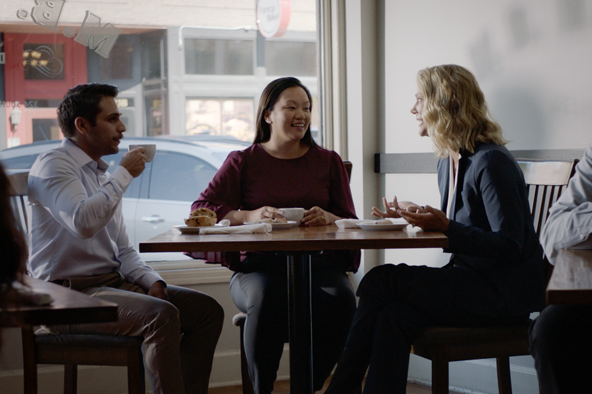 Mortgage Banker Terri Foster sitting at a table in a restaurant with a married couple.