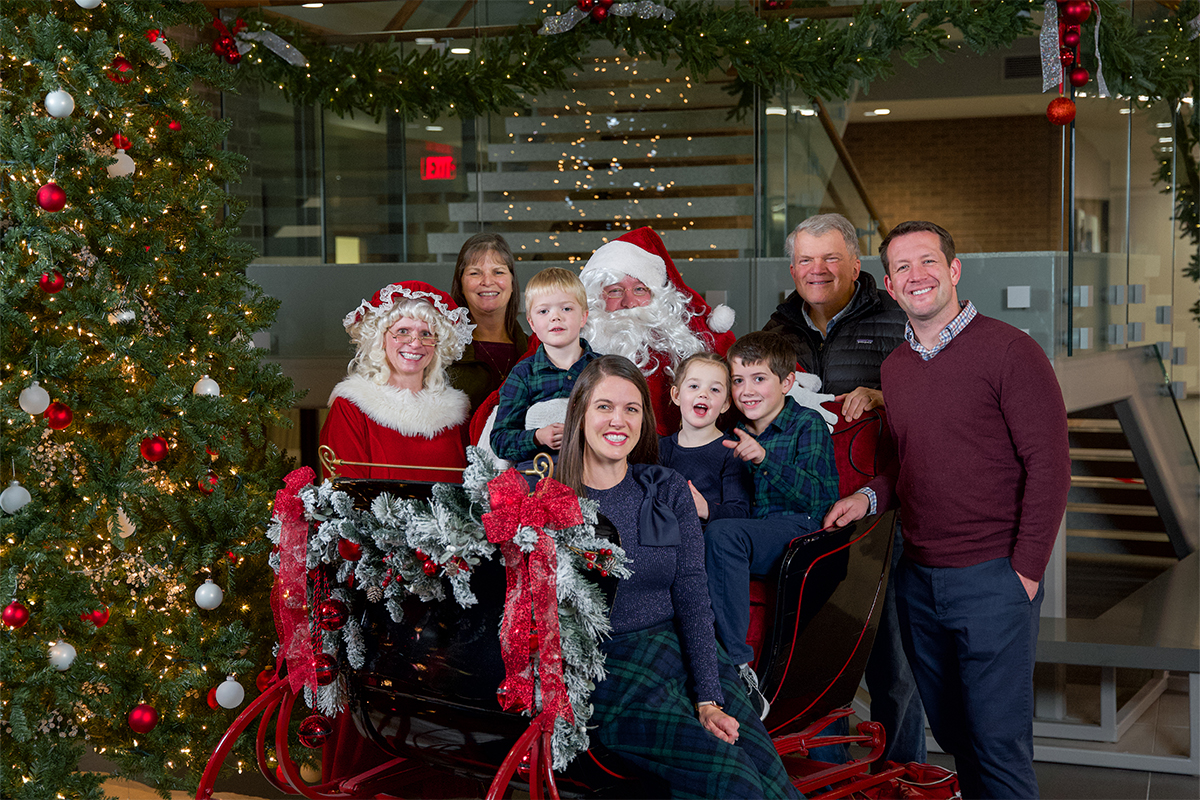 The Groteluschen family posing for a picture with Santa and Mrs. Claus.