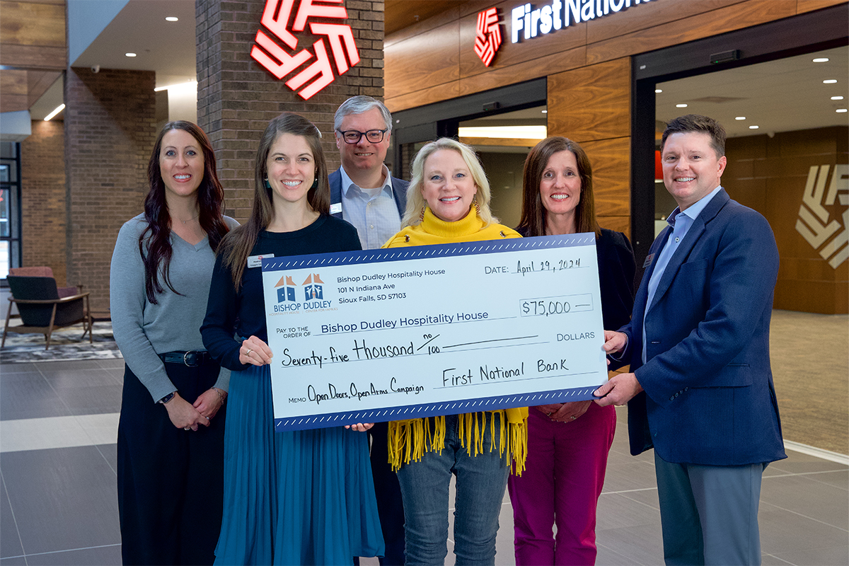 Leadership at The First National Bank in Sioux Falls presenting a check to the Bishop Dudley Hospitality House.