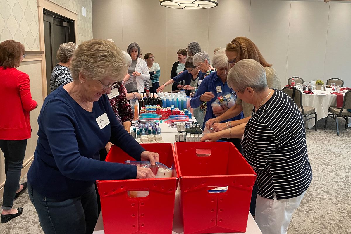 First National Bank retirees assembling hygiene packets for the Bishop Dudley Hospitality House.