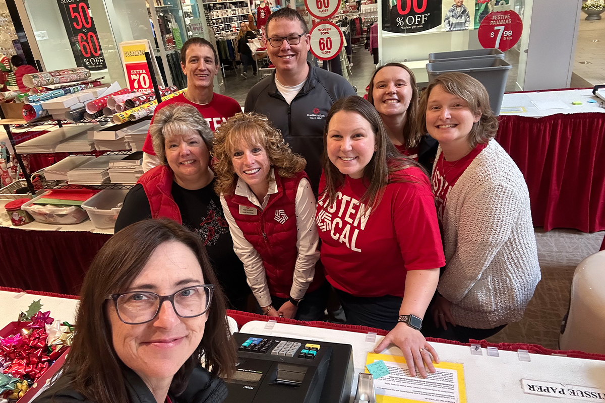 A group of First National Bank teammates volunteering at the Children's Home Society Gift Wrap Booth.