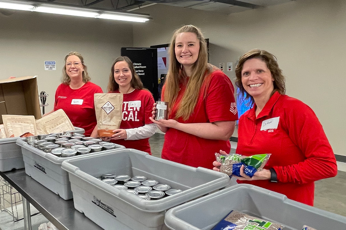 First National Bank teammates packing food boxes at Feeding South Dakota.