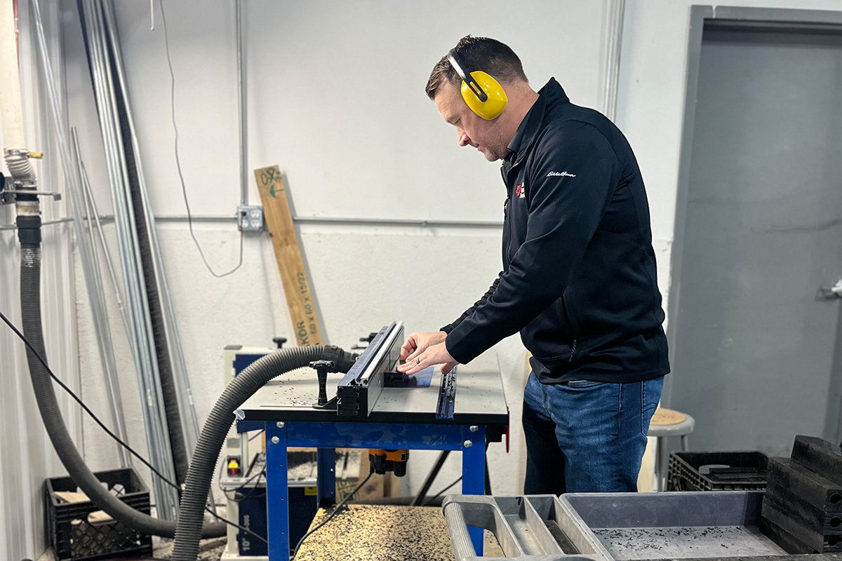 A man cutting materials for wheelchairs at Hope Haven.