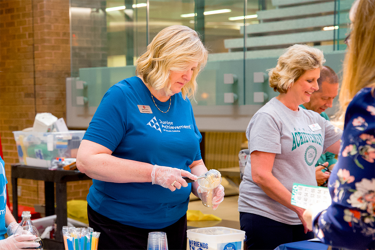 Junior Achievement volunteers scooping ice cream for an ice cream social and fundraiser.