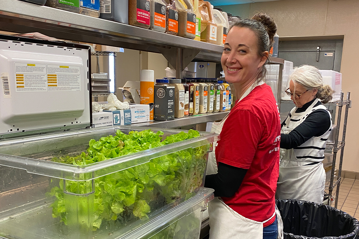 A woman washing lettuce at The Banquet.