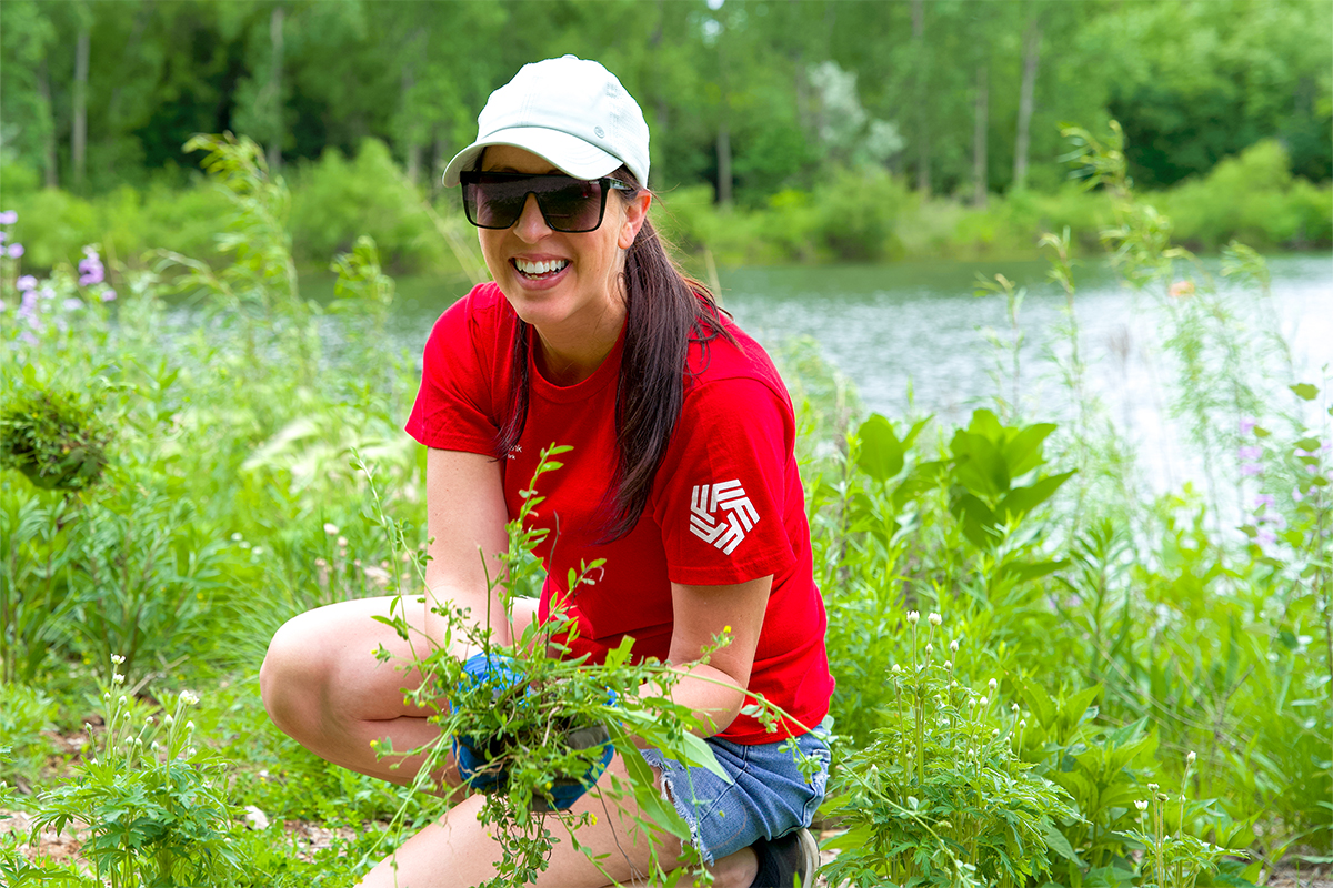 A woman weeding at The Outdoor Campus in Sioux Falls.